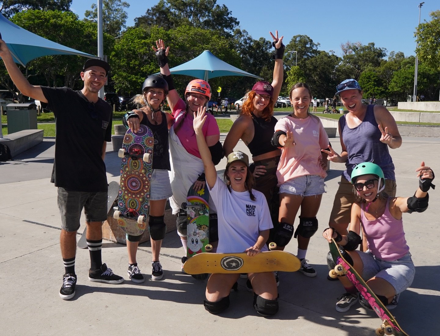 Theo with a group of adult students waving at Pizzey Park